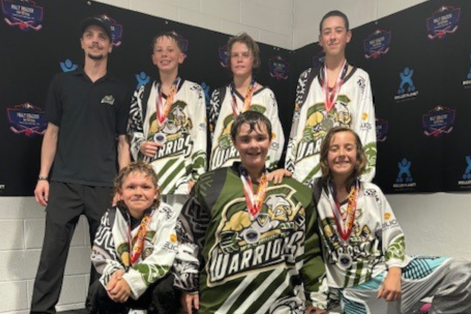 Inline hockey team celebrating a championship win with trophies in Colorado