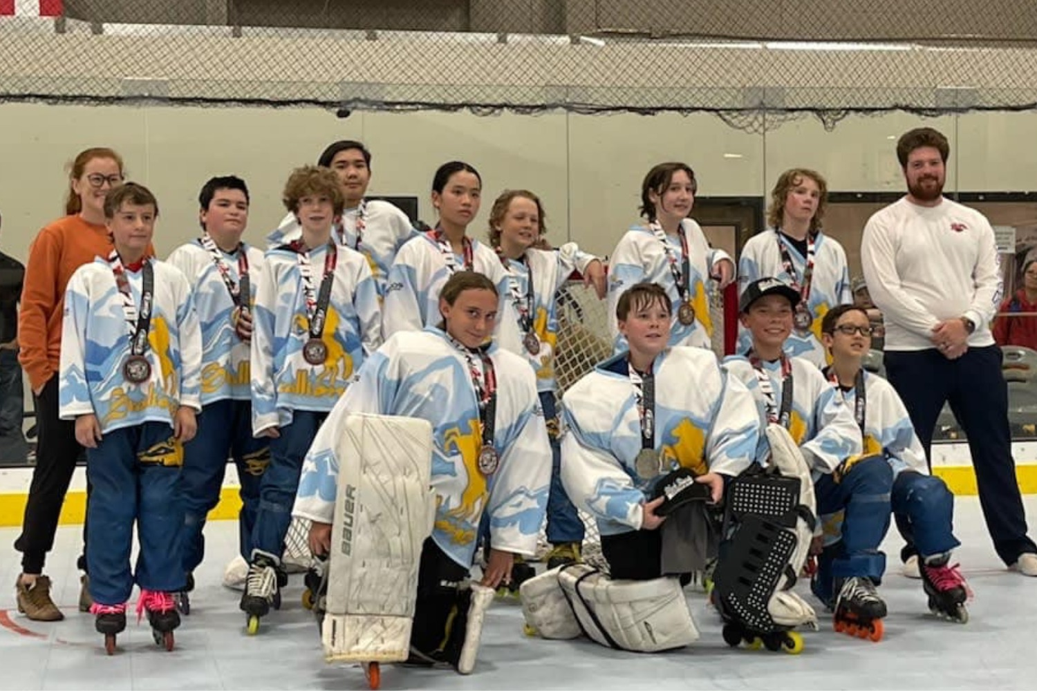 Inline hockey team celebrating a championship win with trophies in Colorado